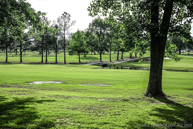 view of home's community with a yard and a water view