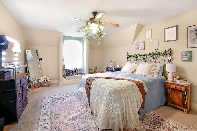 bedroom with light colored carpet, ceiling fan, and vaulted ceiling