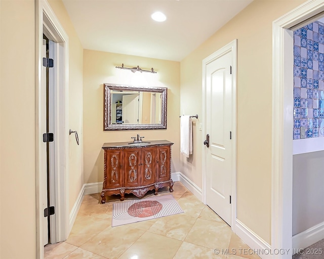 bathroom featuring tile patterned flooring, vanity, baseboards, and recessed lighting