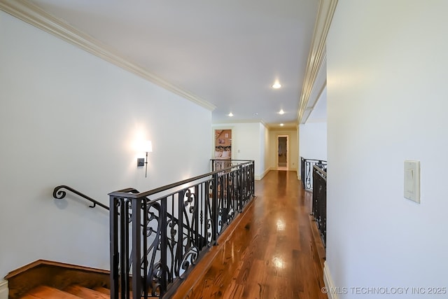 hallway featuring an upstairs landing, crown molding, wood finished floors, recessed lighting, and baseboards
