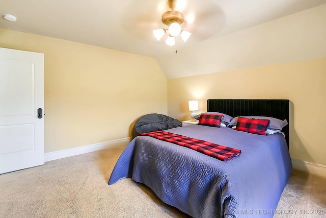 bedroom featuring carpet, baseboards, ceiling fan, and vaulted ceiling