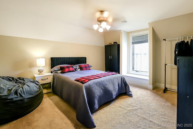 bedroom featuring light colored carpet, ceiling fan, and baseboards
