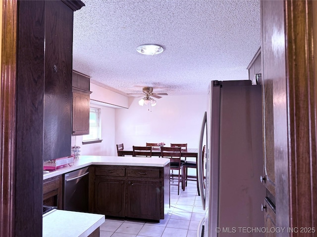 2902 Hilltop Ave, Muskogee, OK 74403 - kitchen featuring appliances with stainless steel finishes, ceiling fan, light countertops, a textured ceiling, and a peninsula