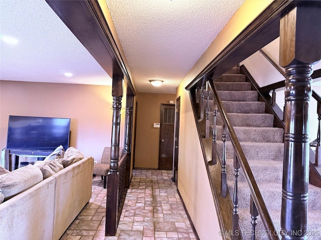2902 Hilltop Ave, Muskogee, OK 74403 - hall featuring a textured ceiling, stairway, and baseboards