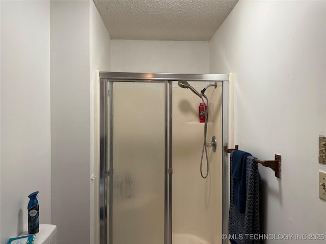 2902 Hilltop Ave, Muskogee, OK 74403 - full bathroom featuring a textured ceiling, a shower stall, and toilet