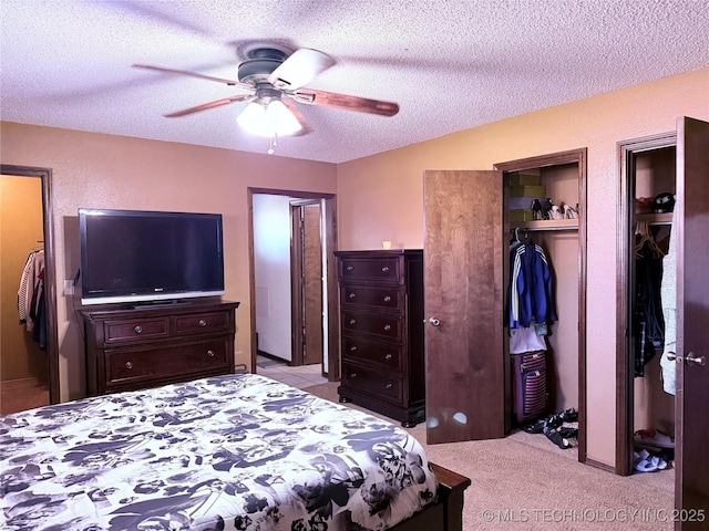 2902 Hilltop Ave, Muskogee, OK 74403 - bedroom with a textured ceiling, multiple closets, and a ceiling fan