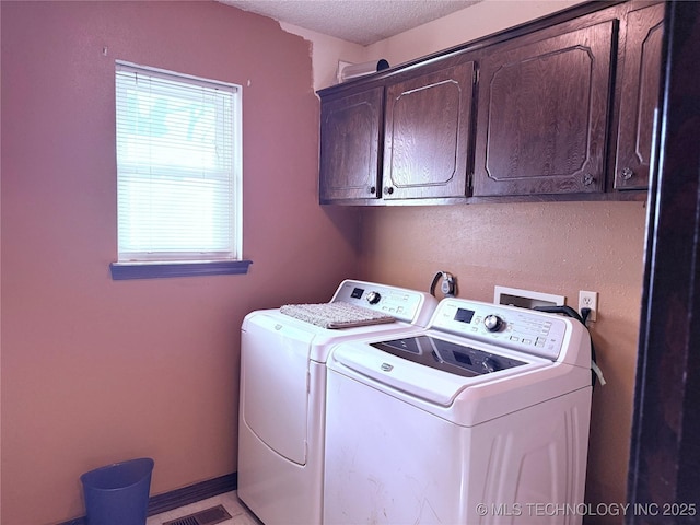 2902 Hilltop Ave, Muskogee, OK 74403 - laundry area with cabinet space, washing machine and clothes dryer, and a textured ceiling