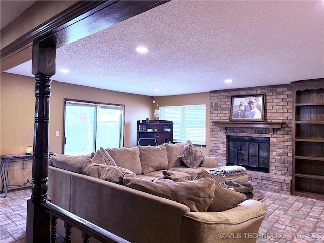 2902 Hilltop Ave, Muskogee, OK 74403 - living room with a textured ceiling, recessed lighting, a fireplace, healthy amount of natural light, and brick patterned floors