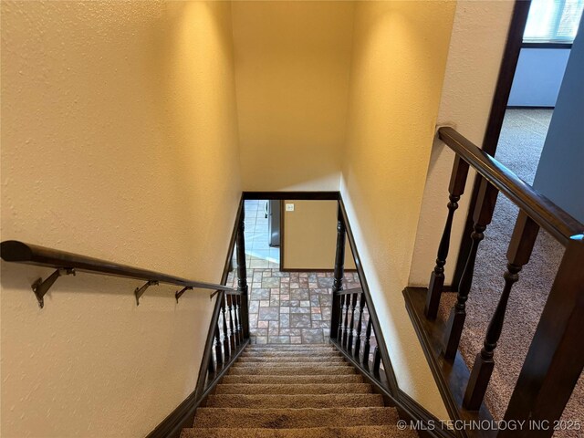2902 Hilltop Ave, Muskogee, OK 74403 - staircase featuring a textured wall, carpet floors, and healthy amount of natural light