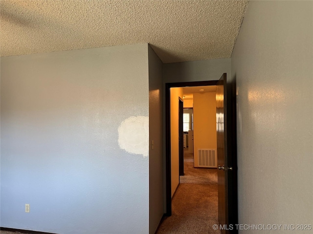 2902 Hilltop Ave, Muskogee, OK 74403 - corridor featuring a textured ceiling and carpet flooring