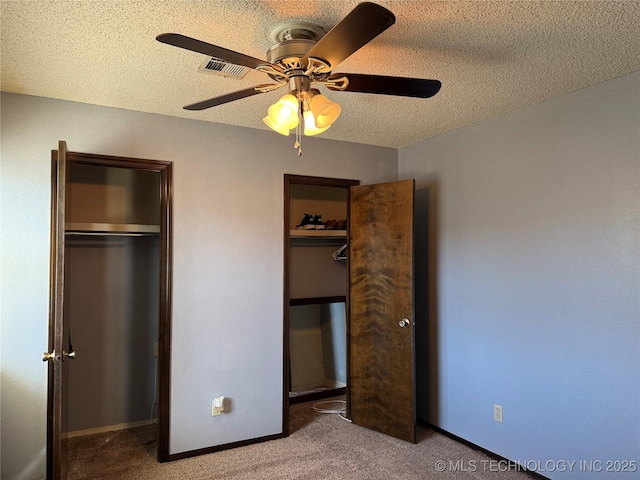 2902 Hilltop Ave, Muskogee, OK 74403 - unfurnished bedroom featuring carpet flooring, multiple closets, a textured ceiling, a ceiling fan, and baseboards