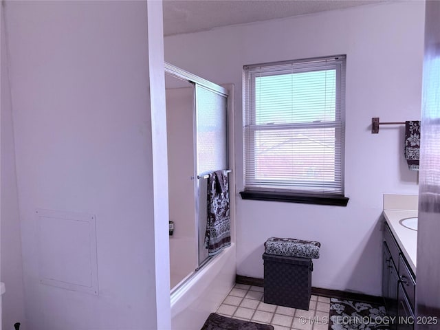 2902 Hilltop Ave, Muskogee, OK 74403 - full bathroom featuring vanity, baseboards, tile patterned floors, and shower / bath combination with glass door