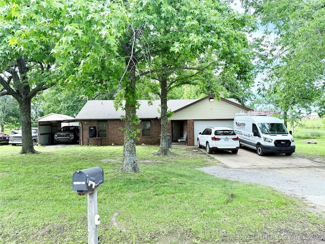 ranch-style house featuring gravel driveway, a garage, a front yard, a detached carport, and brick siding