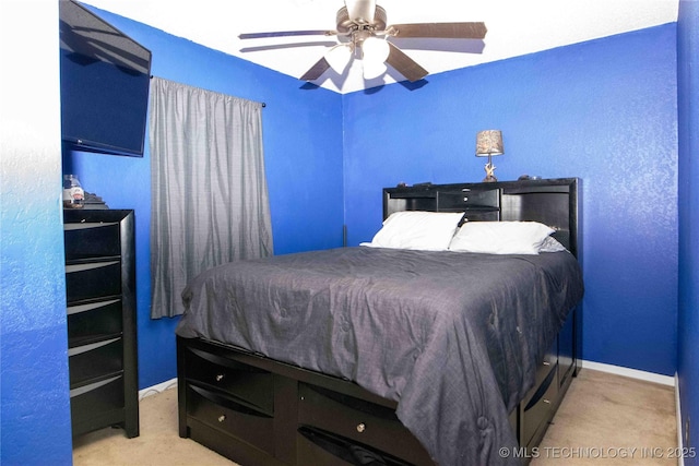 bedroom with carpet flooring, baseboards, and ceiling fan