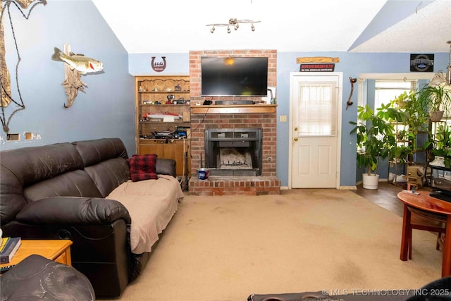 carpeted living room featuring vaulted ceiling and a fireplace