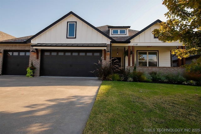 118 W 130th Pl S, Jenks, OK 74037 - view of front of house featuring an attached garage, concrete driveway, a front lawn, and board and batten siding
