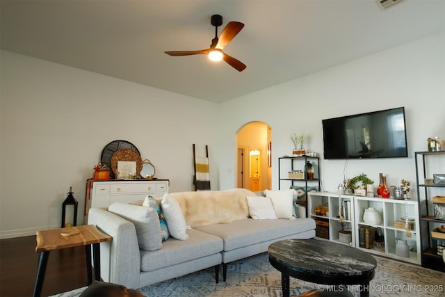 118 W 130th Pl S, Jenks, OK 74037 - living room featuring arched walkways, a ceiling fan, wood finished floors, and baseboards