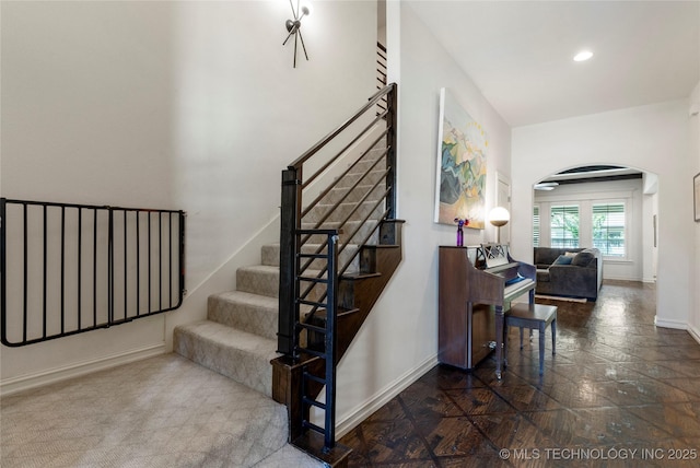 2835 E 104th St, Tulsa, OK 74137 - stairs with arched walkways, baseboards, and recessed lighting