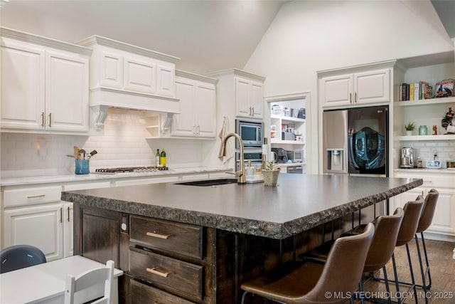 2835 E 104th St, Tulsa, OK 74137 - kitchen featuring appliances with stainless steel finishes, lofted ceiling, open shelves, tasteful backsplash, and a sink