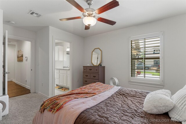 2835 E 104th St, Tulsa, OK 74137 - carpeted bedroom featuring baseboards, a ceiling fan, and ensuite bath