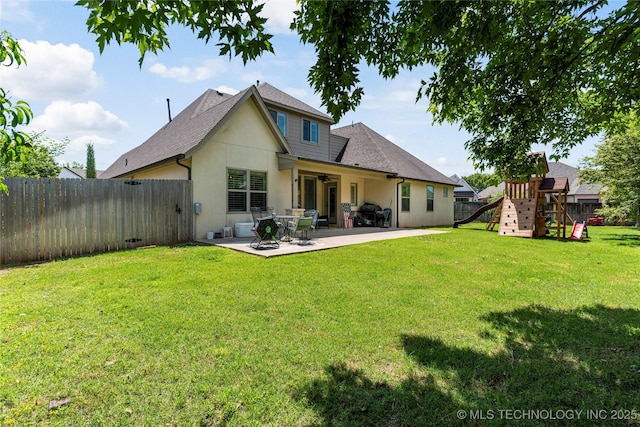 2835 E 104th St, Tulsa, OK 74137 - back of house with stucco siding, a patio, a playground, and roof with shingles