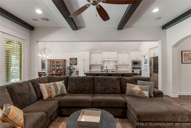 2835 E 104th St, Tulsa, OK 74137 - living room featuring ceiling fan, beam ceiling, recessed lighting, baseboards, and arched walkways