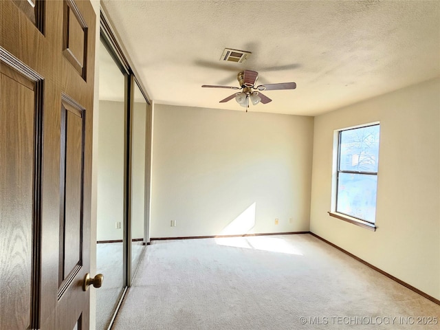 5281 Nowata Rd Unit Q101, Bartlesville, OK 74006 - unfurnished room with light carpet, a ceiling fan, baseboards, and a textured ceiling