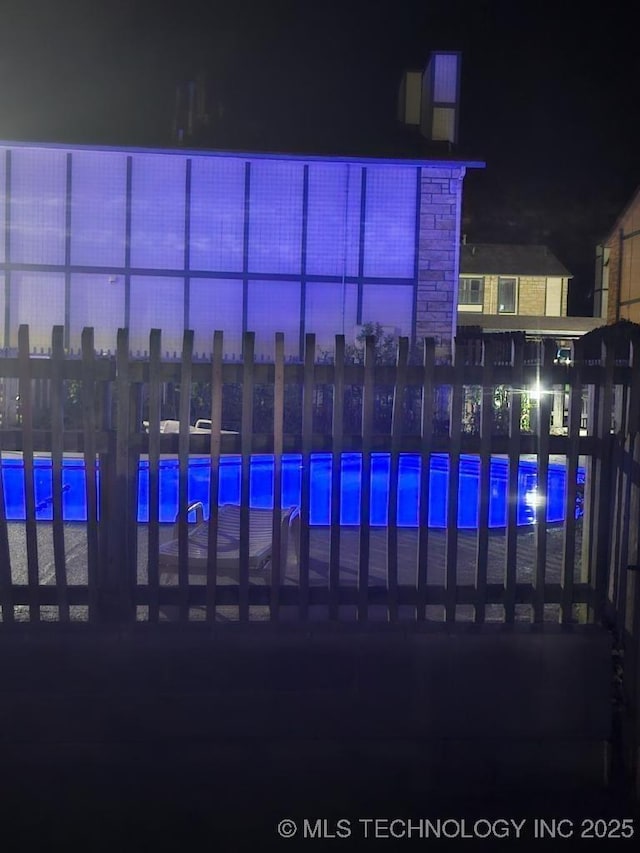5281 Nowata Rd Unit Q101, Bartlesville, OK 74006 - pool at night featuring a community pool
