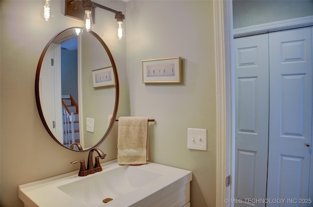 bathroom with a closet and vanity