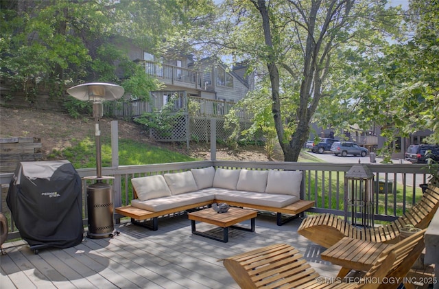 wooden deck with outdoor lounge area and area for grilling