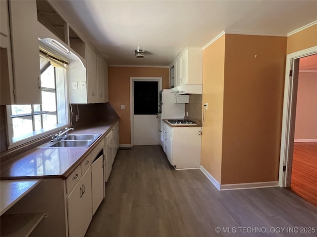 1506 E 46th Pl, Tulsa, OK 74105 - kitchen with white cabinetry, a sink, wood finished floors, tasteful backsplash, and gas stovetop
