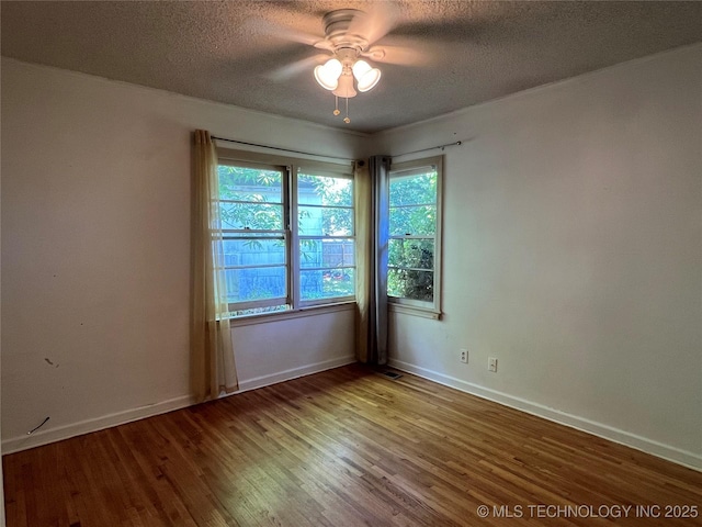1506 E 46th Pl, Tulsa, OK 74105 - unfurnished room featuring wood finished floors, ceiling fan, a textured ceiling, and baseboards