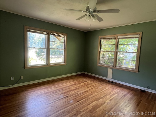 1506 E 46th Pl, Tulsa, OK 74105 - empty room with crown molding, wood finished floors, ceiling fan, and baseboards