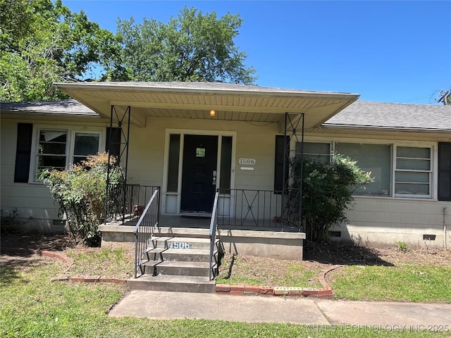 1506 E 46th Pl, Tulsa, OK 74105 - view of exterior entry featuring crawl space, a shingled roof, and covered porch