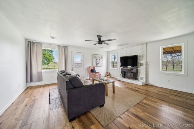 435781 E 130th Rd, Welch, OK 74369 - living area featuring healthy amount of natural light, hardwood / wood-style floors, ceiling fan, and baseboards