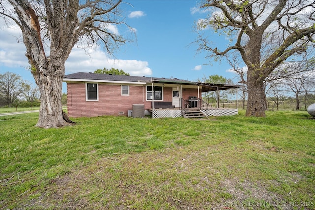 435781 E 130th Rd, Welch, OK 74369 - rear view of house featuring central air condition unit, a lawn, and a wooden deck