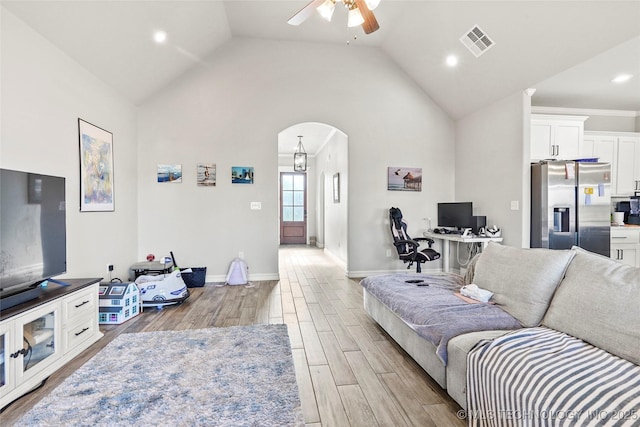 2661 S Catalayah Ln, Claremore, OK 74019 - living room featuring a ceiling fan, light wood-style flooring, arched walkways, vaulted ceiling, and recessed lighting