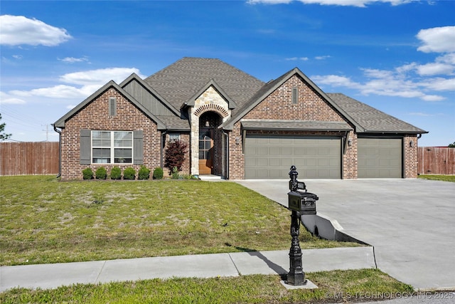 2661 S Catalayah Ln, Claremore, OK 74019 - french provincial home featuring a garage, concrete driveway, brick siding, and roof with shingles