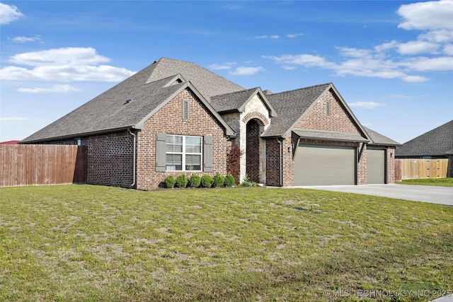 2661 S Catalayah Ln, Claremore, OK 74019 - view of front of house featuring brick siding, a garage, driveway, and roof with shingles