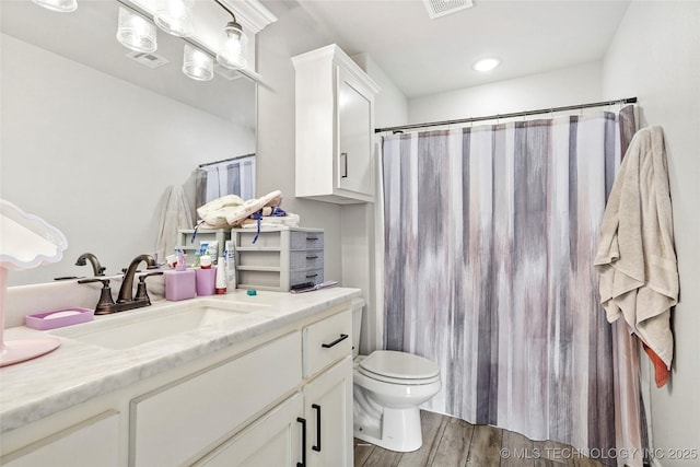 2661 S Catalayah Ln, Claremore, OK 74019 - bathroom with wood finished floors, vanity, toilet, and curtained shower