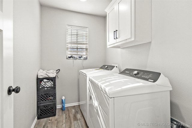 2661 S Catalayah Ln, Claremore, OK 74019 - clothes washing area with washer and clothes dryer, cabinet space, light wood-style flooring, and baseboards
