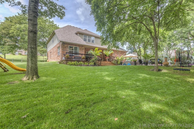 7333 S 286th E Ave, Broken Arrow, OK 74014 - view of yard featuring a trampoline, a wooden deck, and a playground
