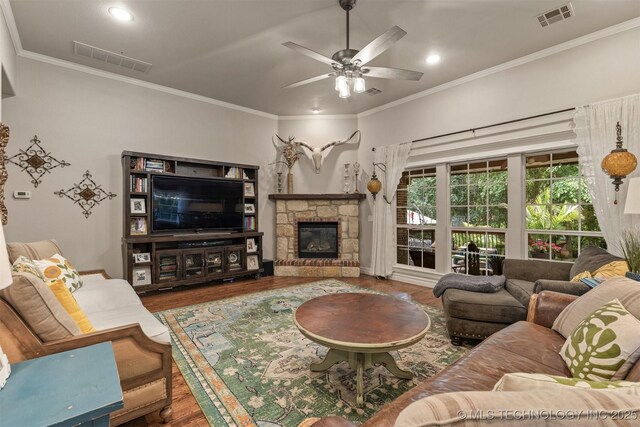 7333 S 286th E Ave, Broken Arrow, OK 74014 - living room featuring wood finished floors, crown molding, a ceiling fan, a stone fireplace, and recessed lighting