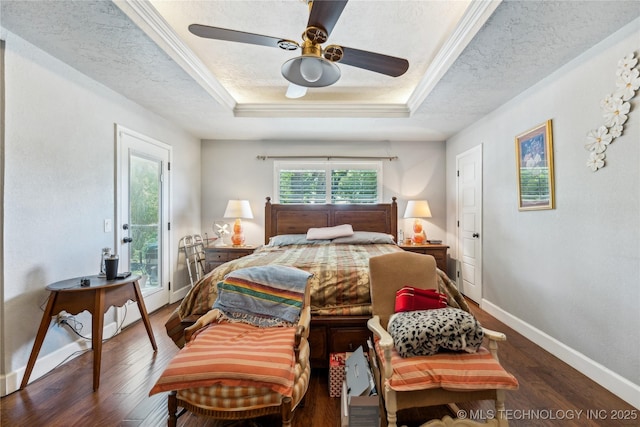 bedroom featuring access to outside, a raised ceiling, wood finished floors, baseboards, and a textured ceiling