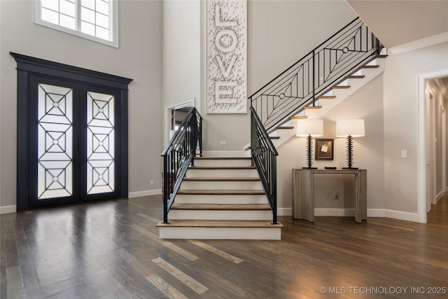 6830 E 109th St, Tulsa, OK 74133 - entryway featuring wood finished floors, baseboards, stairway, and a towering ceiling