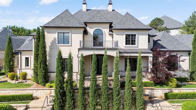 6830 E 109th St, Tulsa, OK 74133 - french provincial home with stucco siding, a balcony, a high end roof, and a chimney