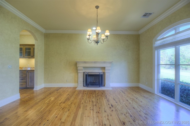 14832 S 53rd E Ave, Bixby, OK 74008 - unfurnished living room featuring wood finished floors, a chandelier, crown molding, arched walkways, and baseboards