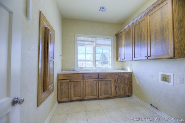 14832 S 53rd E Ave, Bixby, OK 74008 - clothes washing area featuring cabinet space, washer hookup, baseboards, and light tile patterned flooring