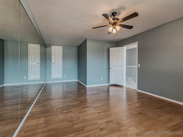 15412 E 78th St N, Owasso, OK 74055 - empty room featuring a ceiling fan, baseboards, and wood finished floors