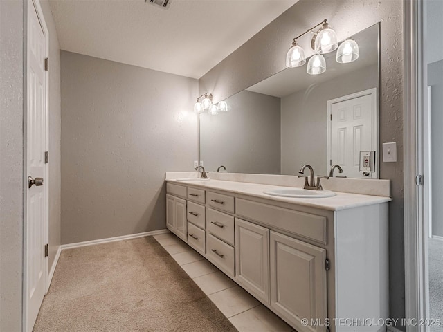 15412 E 78th St N, Owasso, OK 74055 - full bathroom featuring double vanity, baseboards, a textured wall, and tile patterned flooring